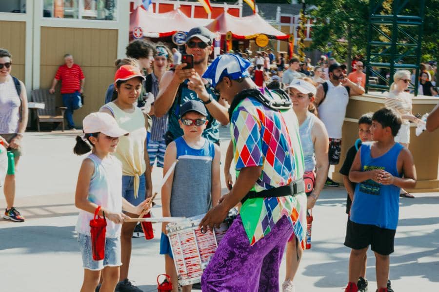 A performer interacts with guests during Grand Carnival at Worlds of Fun