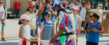 A performer interacts with guests during Grand Carnival at Worlds of Fun