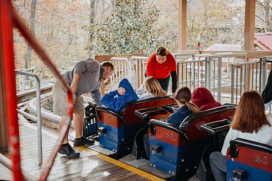 Employees help board coaster at Worlds of Fun