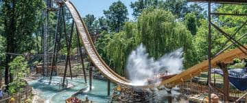 Action image of the Familypark water-log attraction Biberburg (Beaver Castle). The flume ride lodge takes guests up high at 17 meters, then rushes down with a big splash.