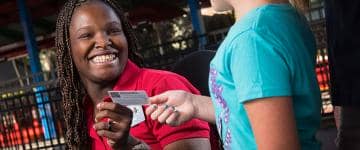 Theme park employee helping guest