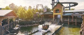 Guests are splashed at the bottom of the Mystic River Falls water flume attraction at Silver Dollar City.