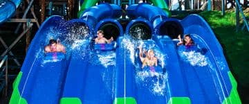 Riders embark on a ride down a slide at Noah's Ark water park.