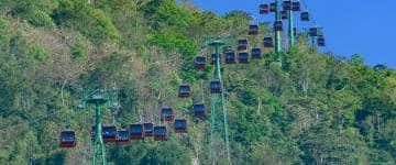 Dozens of sky ride cabins on a mountain side cable way attraction