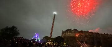 Fireworks illuminate the sky in the middle of a solar eclipse at Six Flags Fiesta Texas in San Antonio