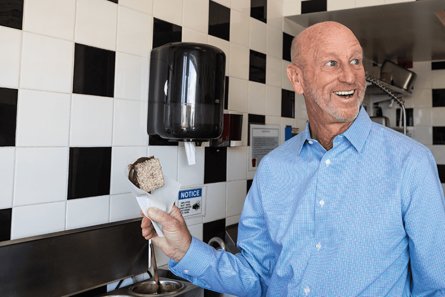 Ken Whiting holding Santa Cruz Boardwalk signature snack 