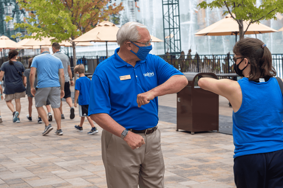 Mike Koontz gives elbow bump to guest 