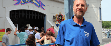 Cory Hutchinson standing in front of a ride queue at Funtown Splashtown USA