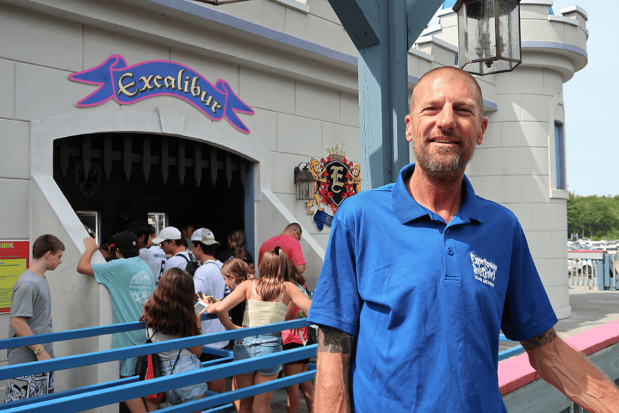 Cory Hutchinson standing in front of a ride queue at Funtown Splashtown USA