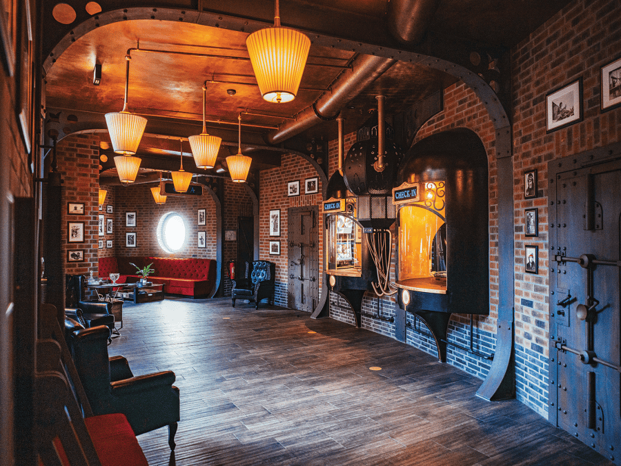 The hotel lobby features vacuum tube-like windows that serve as a check-in desk.