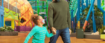 Mall of America - Nickelodeon Universe - Father and Daughter walking by huge pineaple