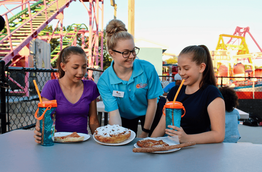 Employee talks to two young guests 