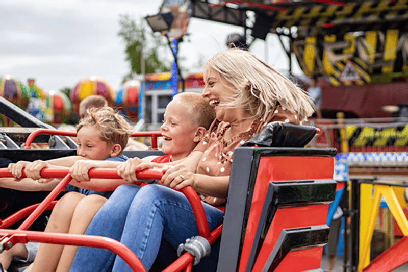 Family laughs on a ride at Web Adventure Park 